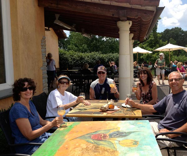 Group sitting on patio at winery on a summer day