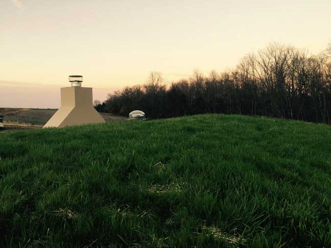 Earthen shelter Living Roof with grasses and chimney overlooking Shawnee Forest