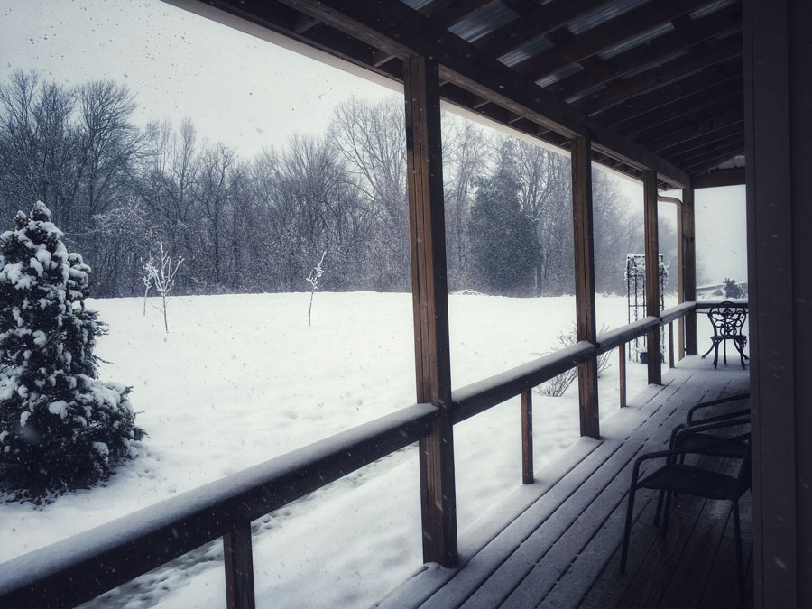 Snow covered porch Creole Cabins
