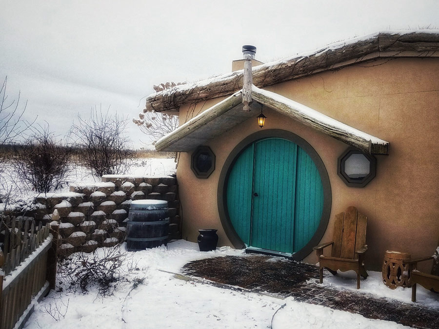 Snow covered Cabin The Cove with round blue door