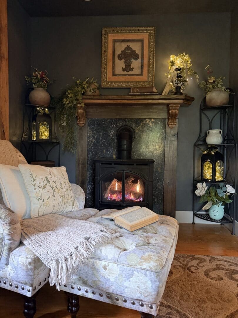 Cozy reading nook at the French Creole Cabin with a fireplace, soft chair, warm lighting, and rustic decor.