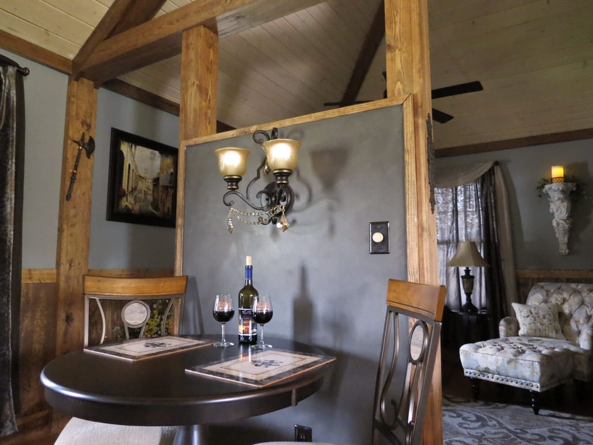 Intimate dining table for two beneath a French-style wall sconce in the French Cabin.